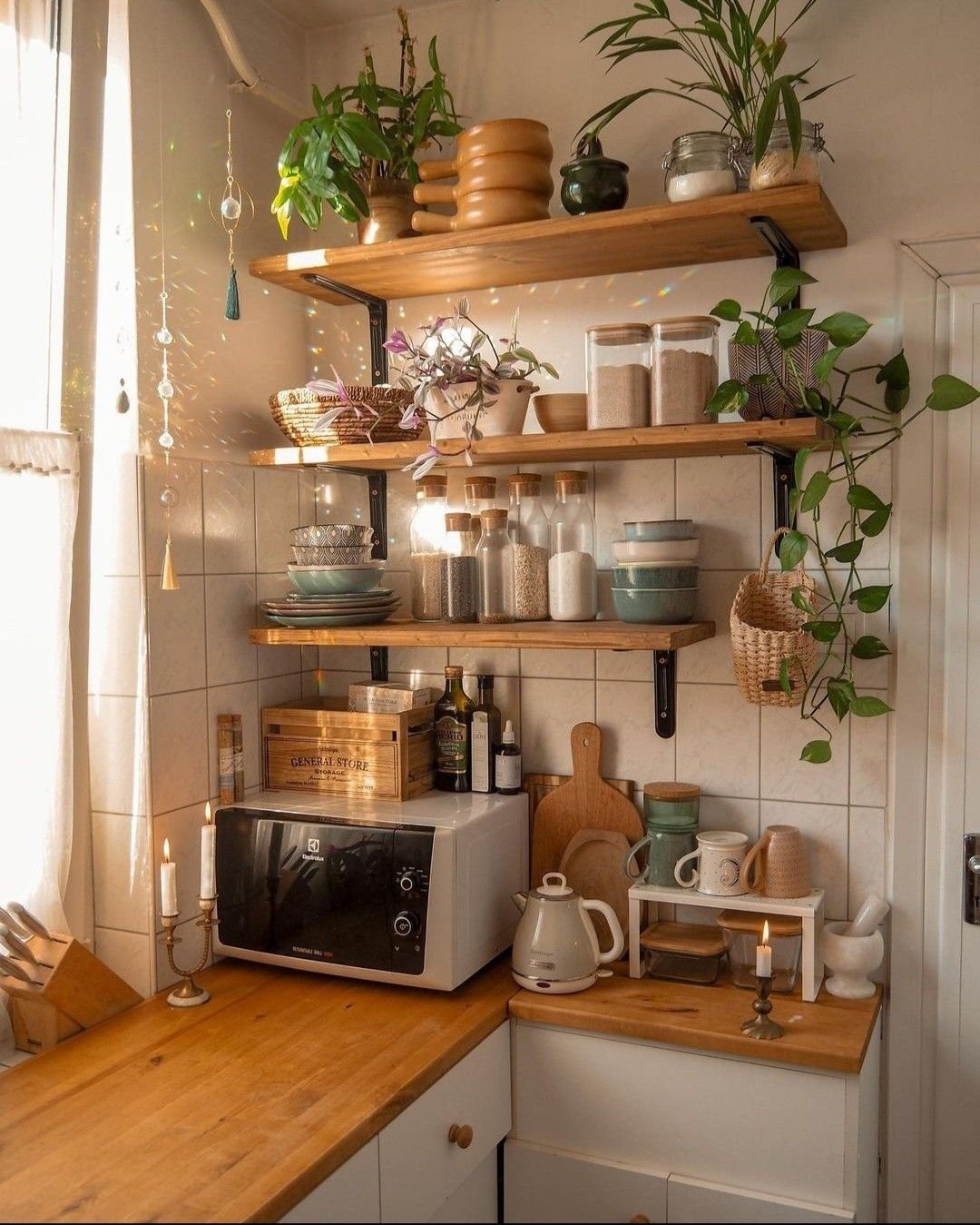 Kitchen shelves styled with ceramics, glassware and warm wood